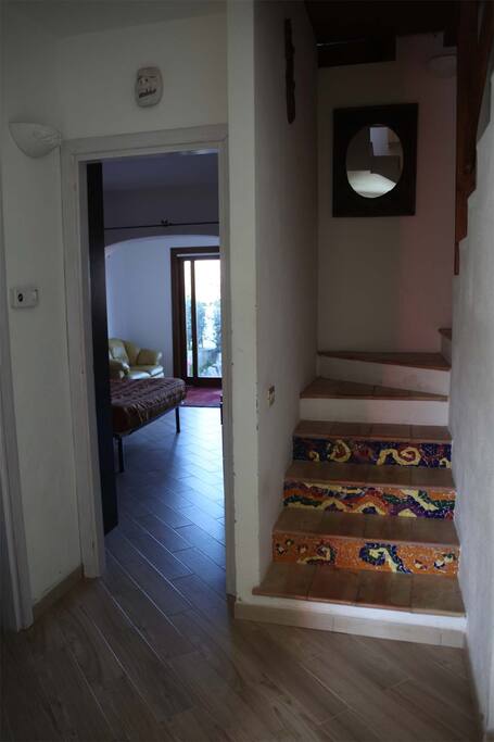 Stairs leading to living room, dining room and kitchen. Entrance to spacious master bedroom.
