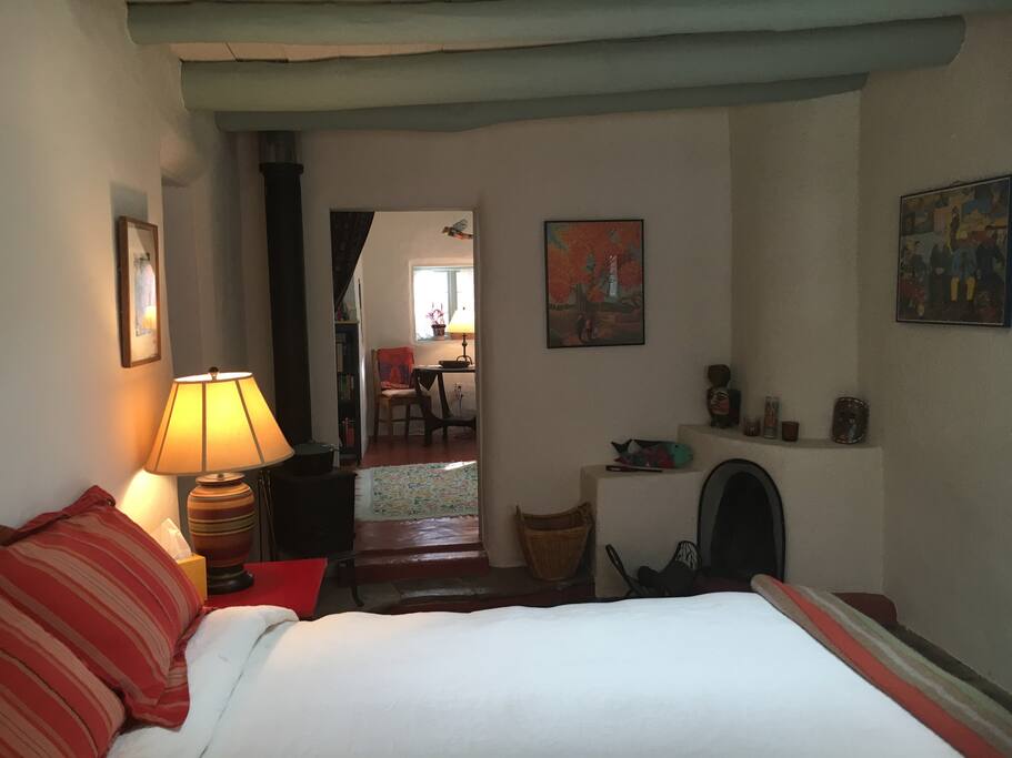 Note kiva fireplace and woodstove in main bedroom