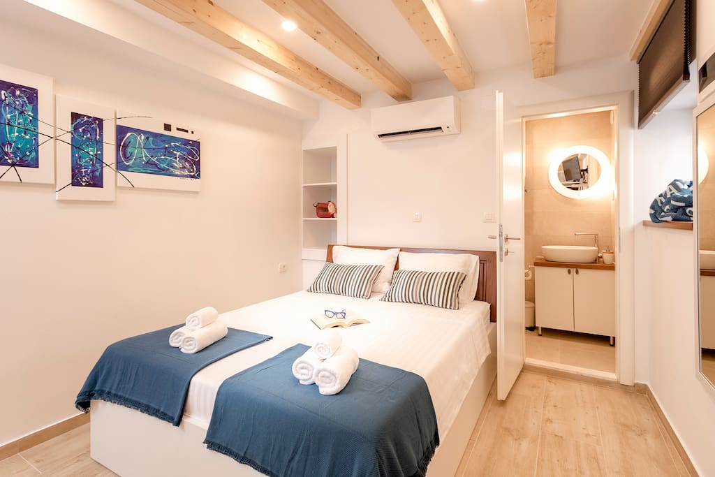 Double bed with the connected bathroom. The room has A/C and satellite smart TV