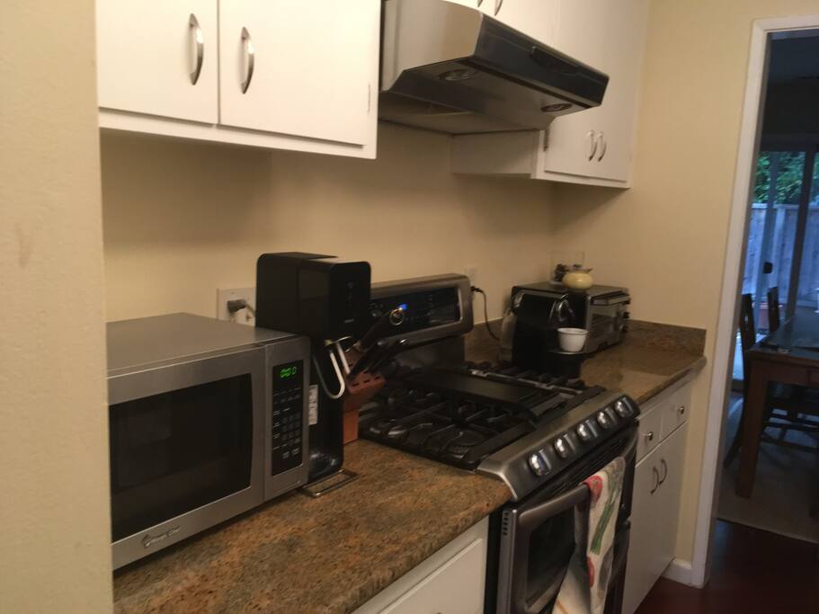 Stove, microwave, coffee maker, cabinet space.