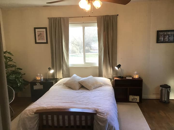 A large, airy room with full size futon bed with a new mattress. It has a small refrigerator and no AC as of yet. 