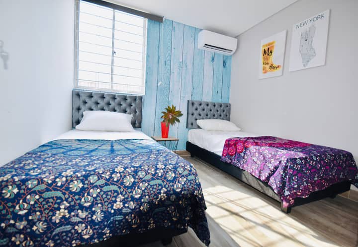 חדר עם שתי מיטות יחיד, מואר ומיזוג אוויר.