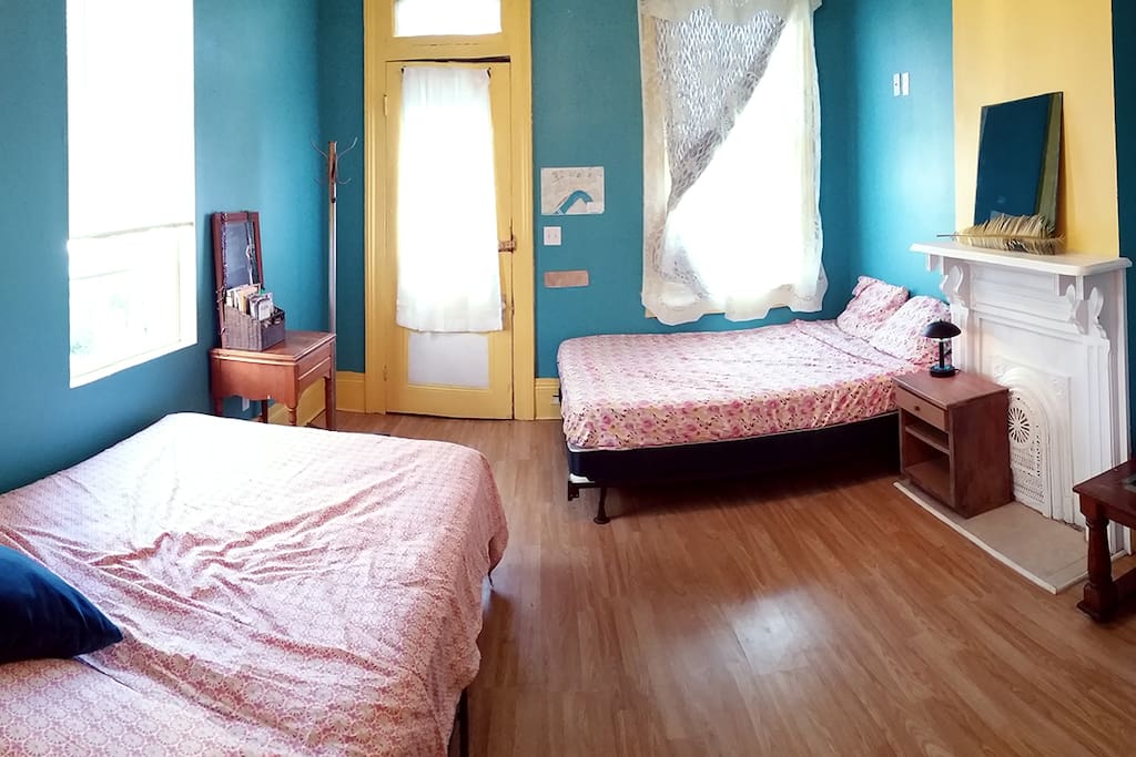 The lovely teal front room is bright and sleeps up to four people. It leads right into the next room, for a slumber party sort've feel.