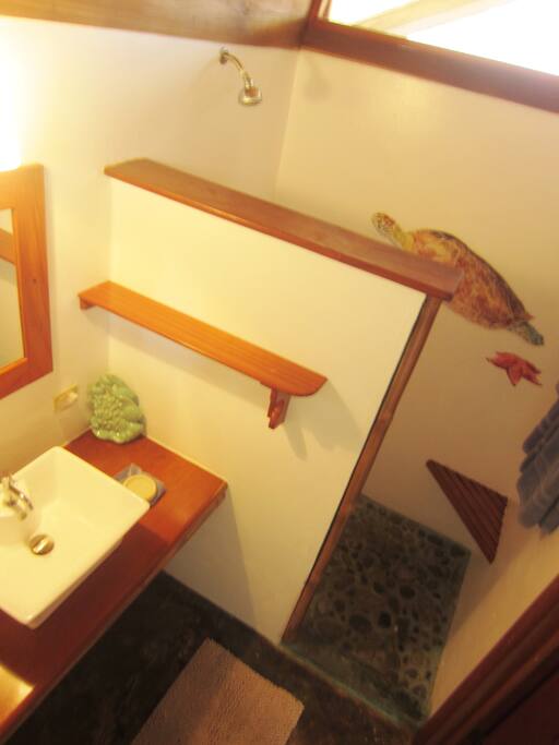 Sea turtle mural in the river rock floored shower