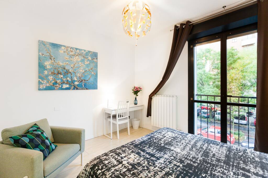 Foto verificata air bnb camera da letto vista frontale, tende oscuranti, poltrona per relax guardando il parco, comoda console per lavorare con netbook in wifi fibra ottica, e "mandorlo in fiore" di Van Gogh