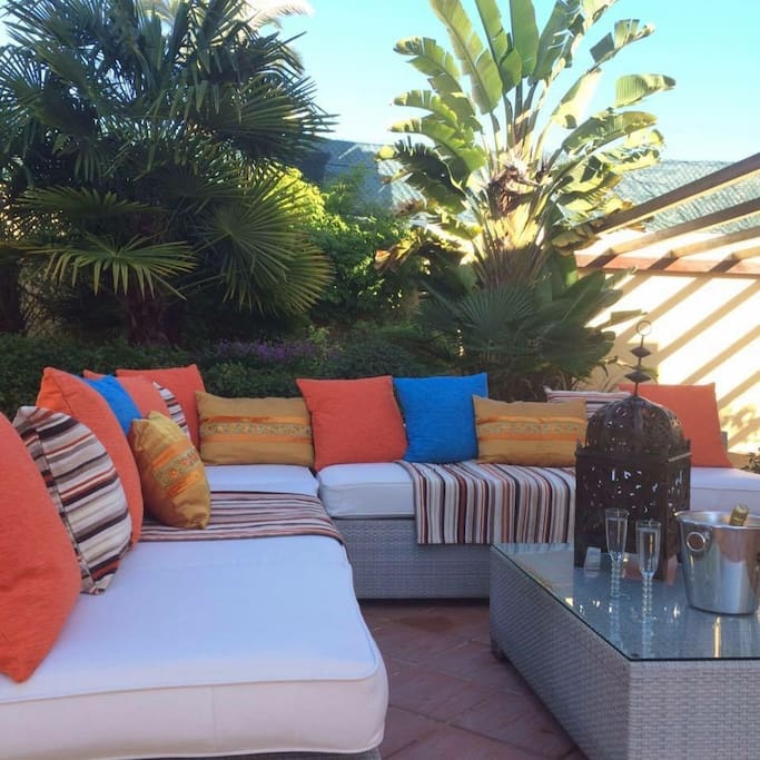 Large L shaped sofa situated via large patio doors. A great place to relax and can be either in shade with the use of a large sun shade umbrella or in full sunshine.