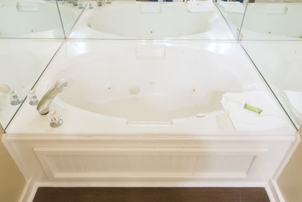 Master In-Suite Jacuzzi Tub with three walled Mirrors