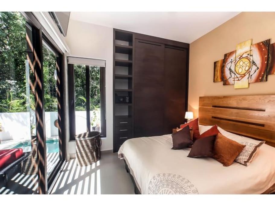 Master bedroom with king size bed facing the private patio