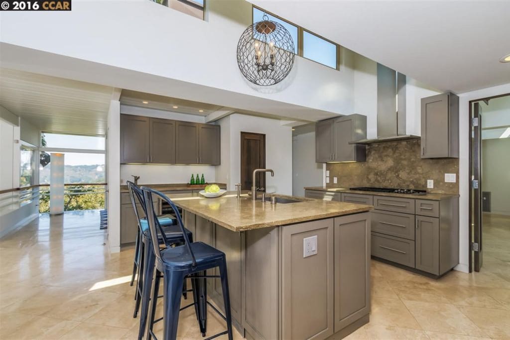 Large kitchen with Wolf range, 2 stoves, and a Sub Zero fridge/freezer.