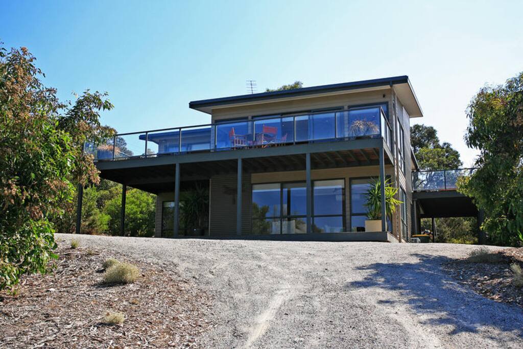 Front of property with plenty of parking space (outside shower)