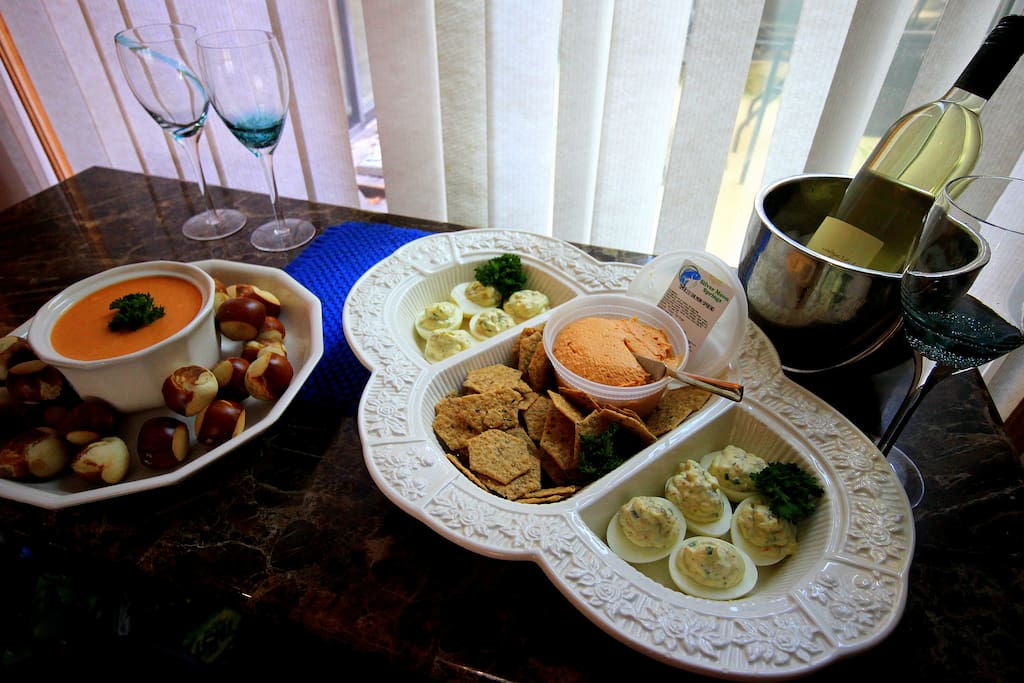 Sample arrival appetizers of Beer cheese dip with German soft pretzel bites, deviled eggs, smoked salmon spread, and crackers