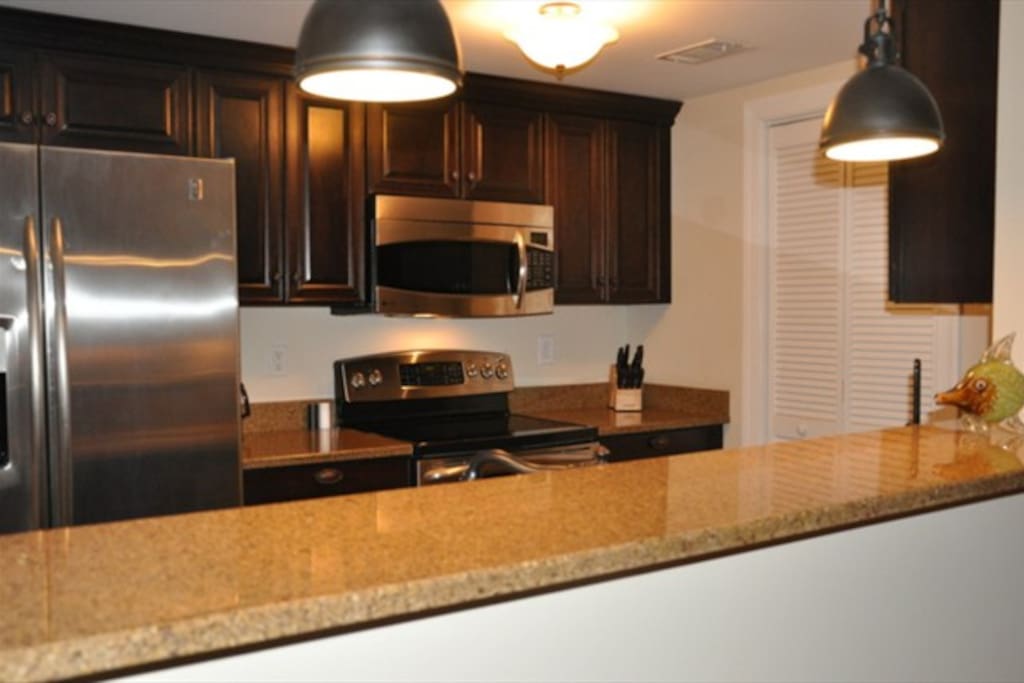 Fully equipped kitchen with granite counter tops, stainless appliances
