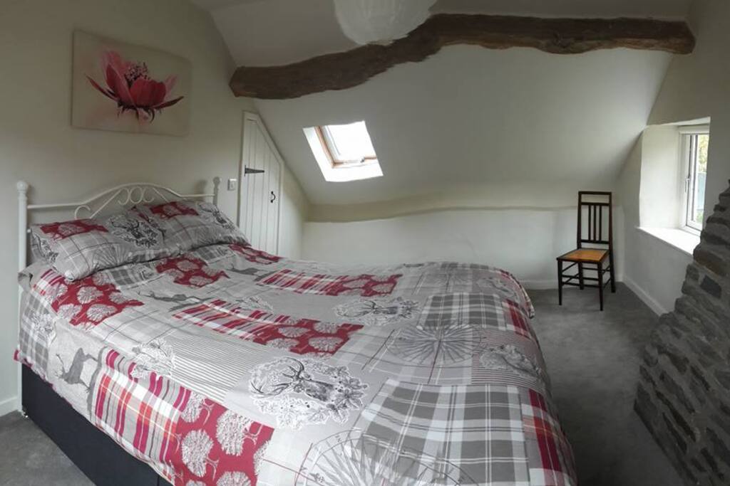 Beamed master bedroom with field views, king size bed, wardrobe & drawers.