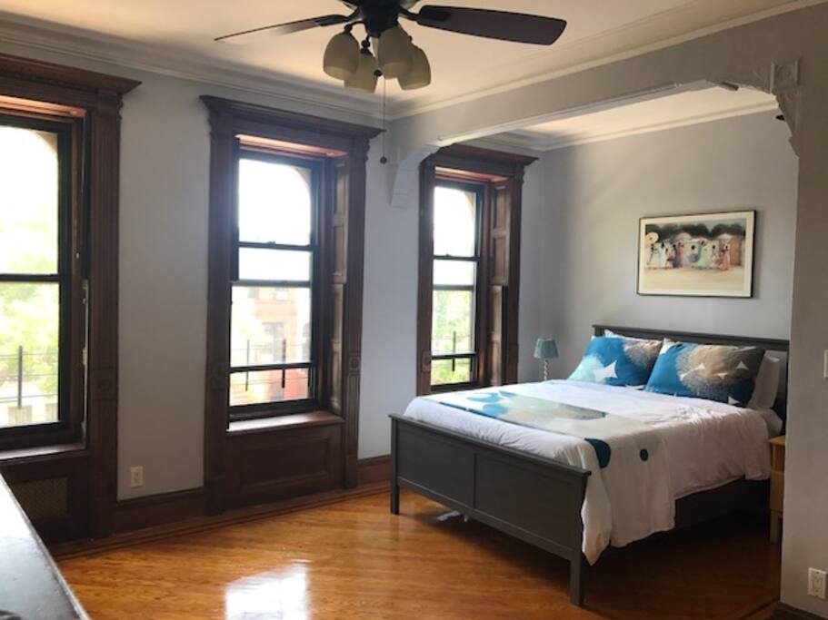Large, airy bedroom with queen bed, large windows & lots of closet space