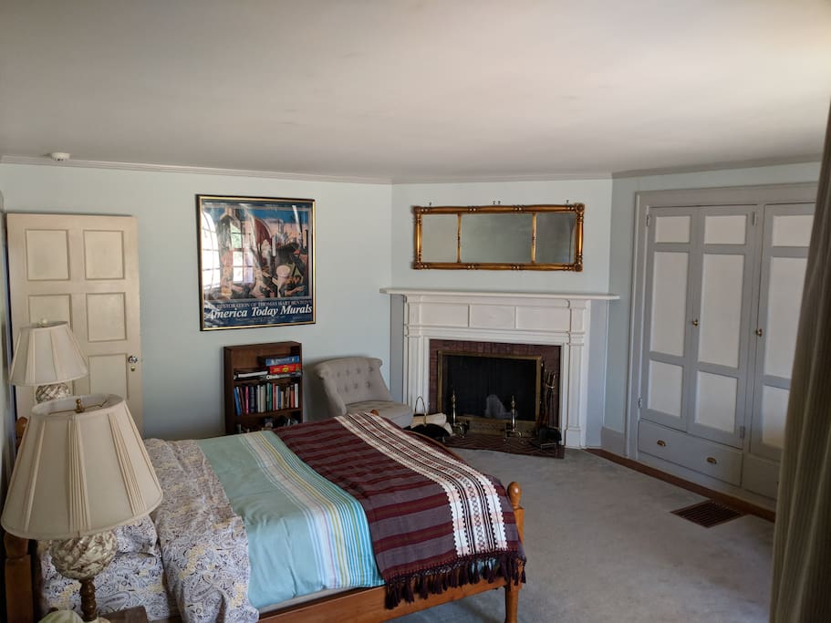 Decor includes beautiful antique mirror over the fireplace and built-in cabinets.