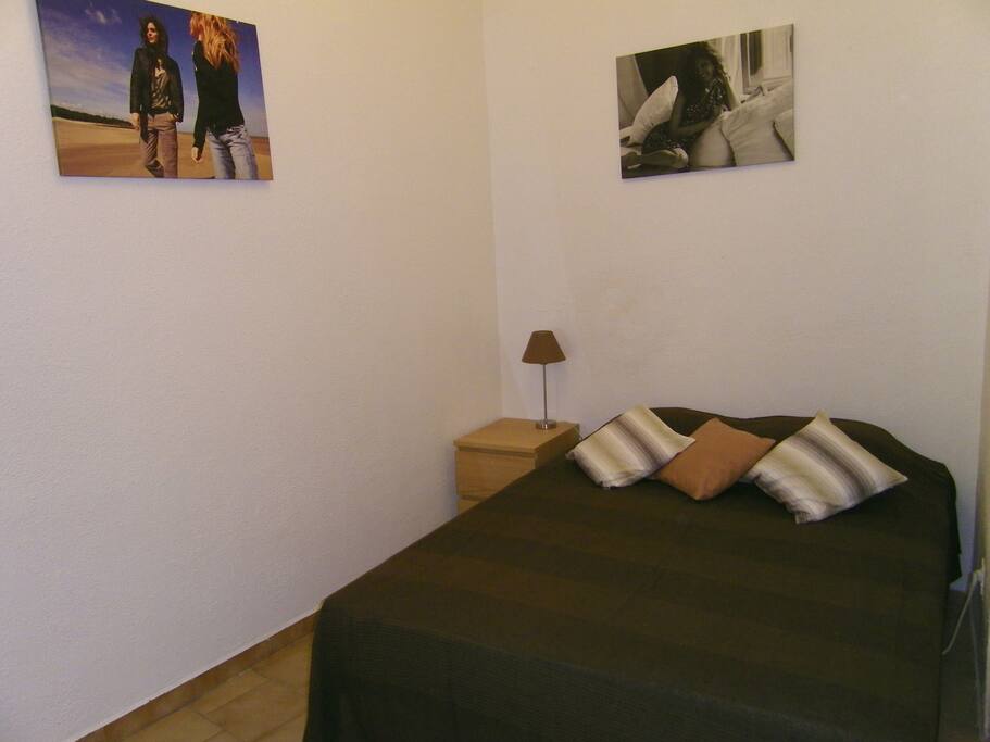 Real double bed with half-wall hiding kitchen view!