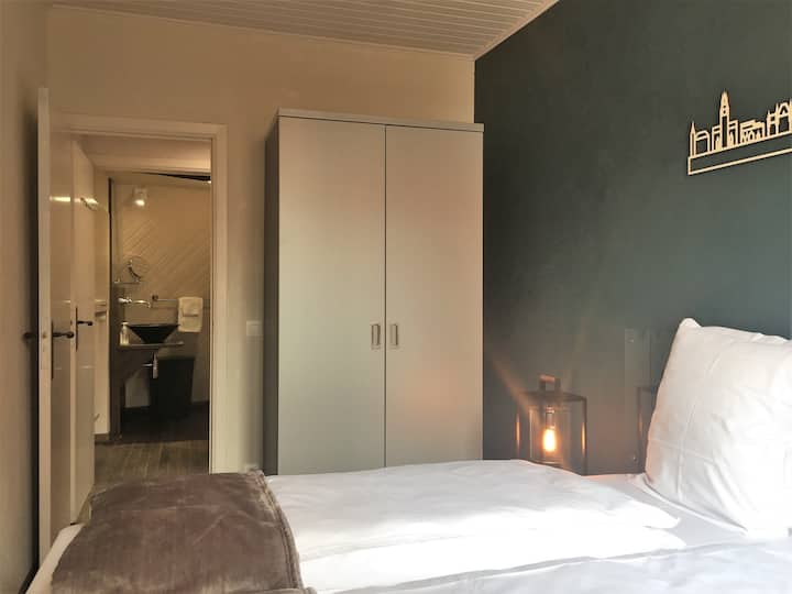 Blue room and view into bathroom, wardrobe