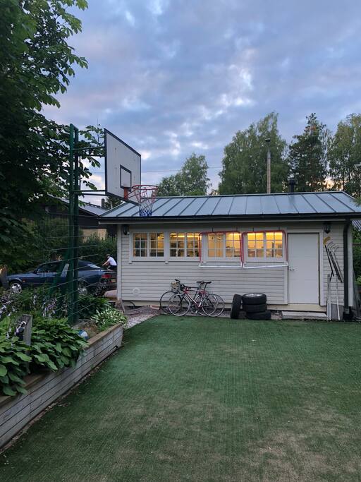 Basketball court in front yard.