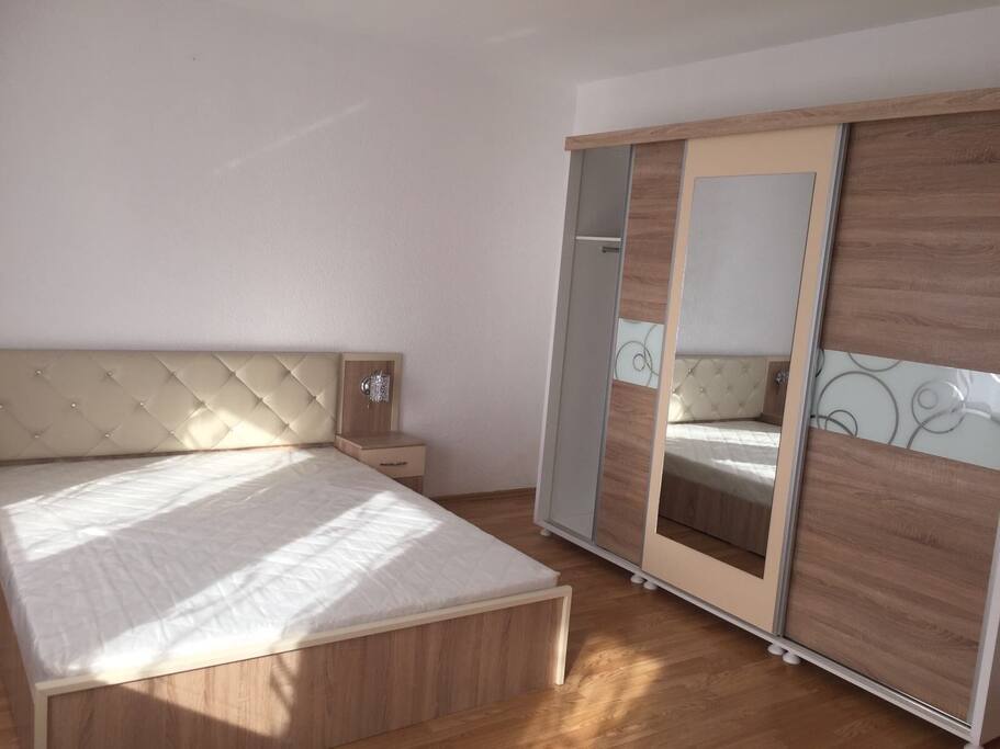 Bedroom with big size bed for 2 and closet