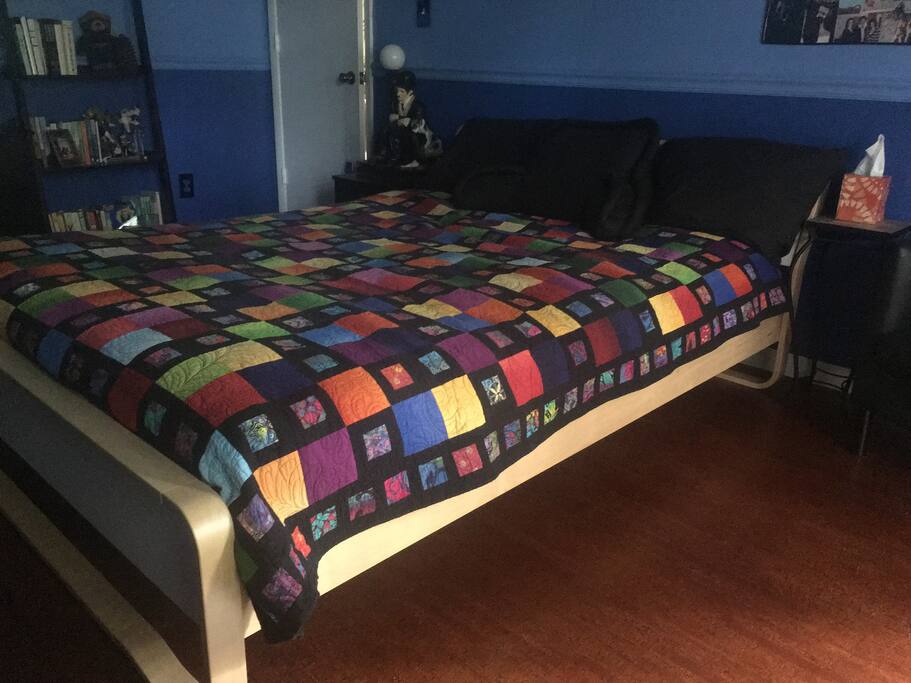 Comfy bed and handy closet and bureau for belongings.