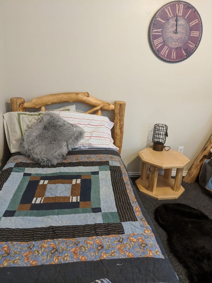 Comfortable twin log bed with homemade denim quilts.  