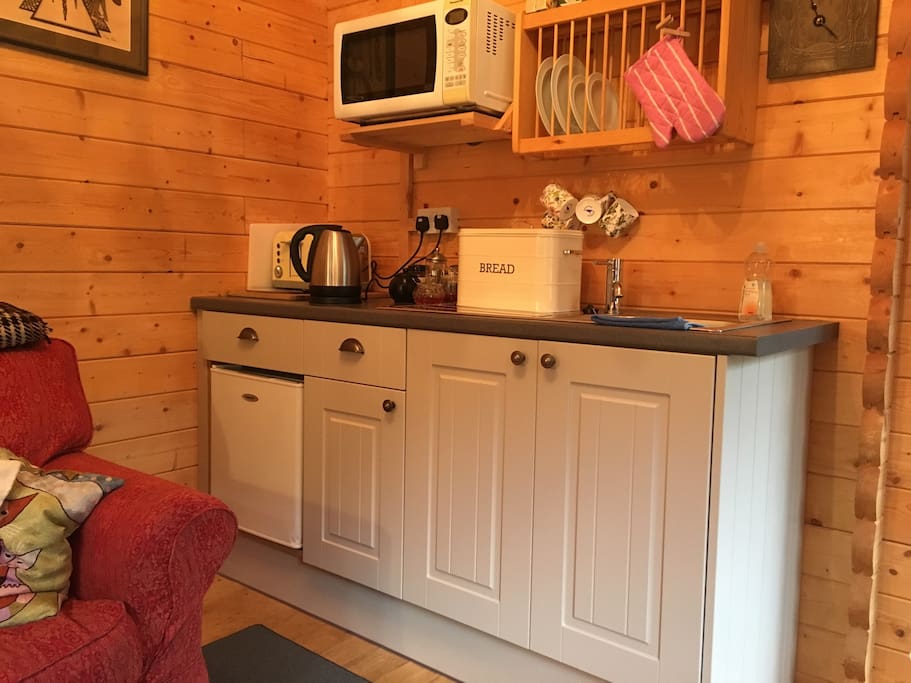 Kitchen area. There's a microwave, a toaster and a fridge.