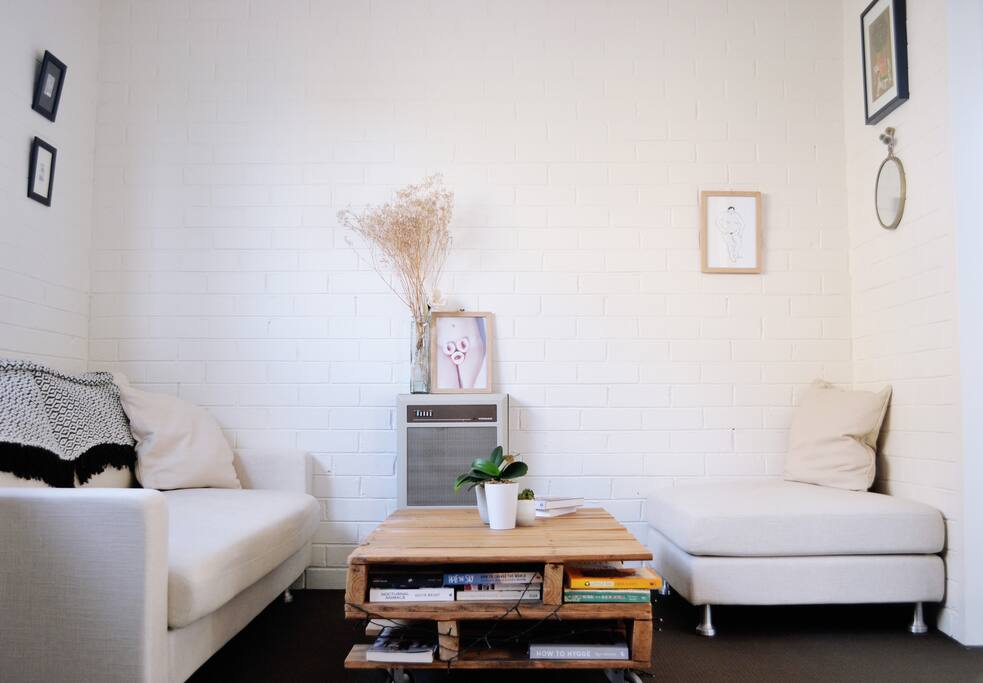 A light-filled living room with a great stereo system for you to plug your phone into! The coffee table is filled with plenty of cookbooks and novels to read.