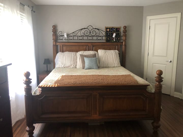 King size bed with fresh linens, Pottery Barn bedding, pillows and firm mattress. Reading lights above the bed. 