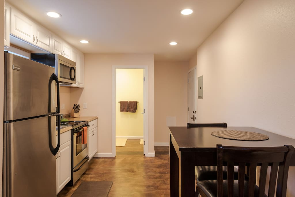 Full kitchen and table and chairs for two.