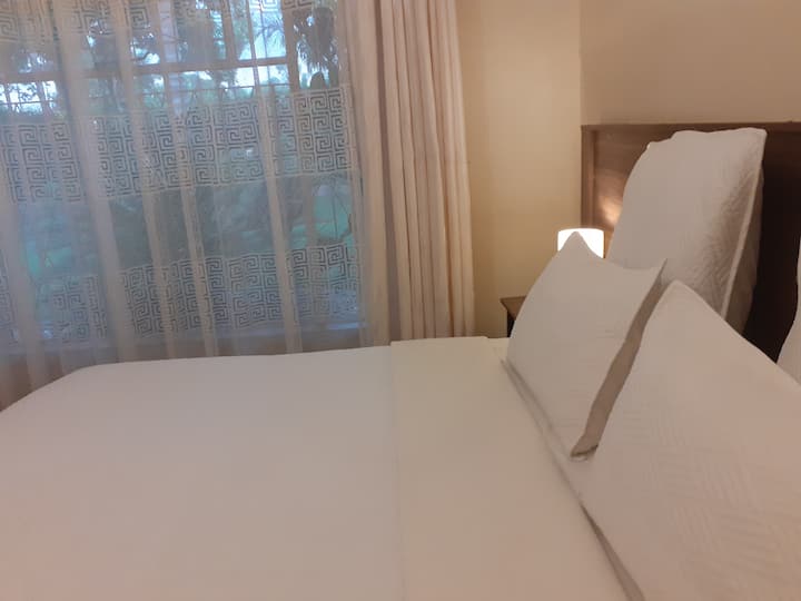 The Master Bedroom with an ensuite bathroom with a Jacuzzi Bath and a stand alone shower. It has its own private entrance plus a private patio. There is an option to have an Extra large King sized bed or twin 3/4 beds