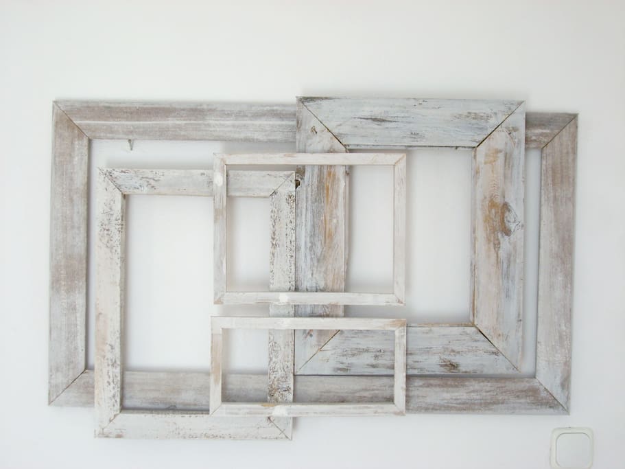 The decoration above the bed, made from recycled wood.