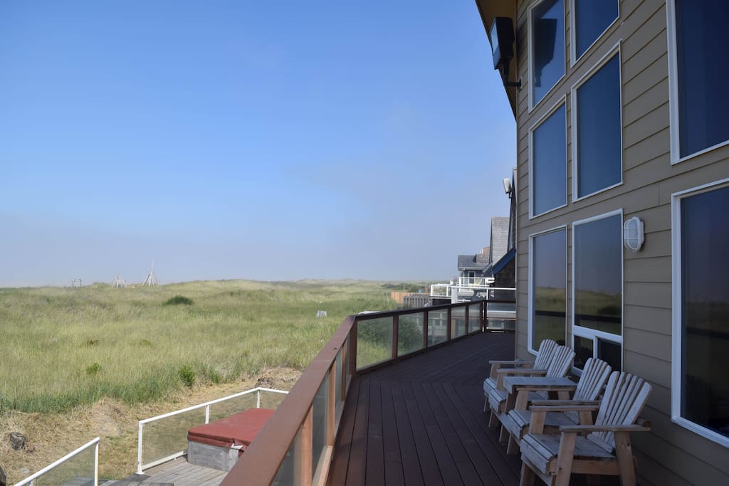 Upper deck view of dunes and ocean, from an angle.