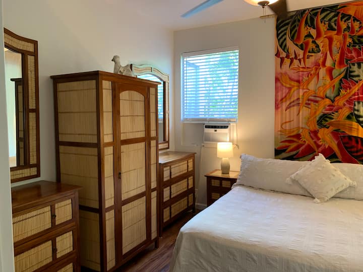 Beautifully decorated bedroom with comfortable king size bed, 2 large dressers, and matching armoire with hangers. 