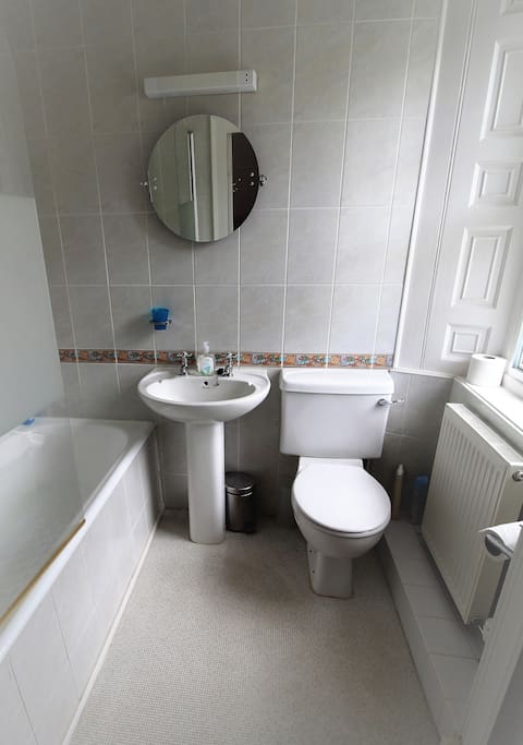 En suite bathroom with shower over the bath