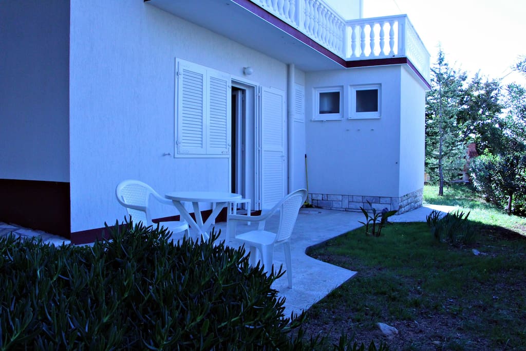 The terrace is surrounded by Mediterranean vegetation