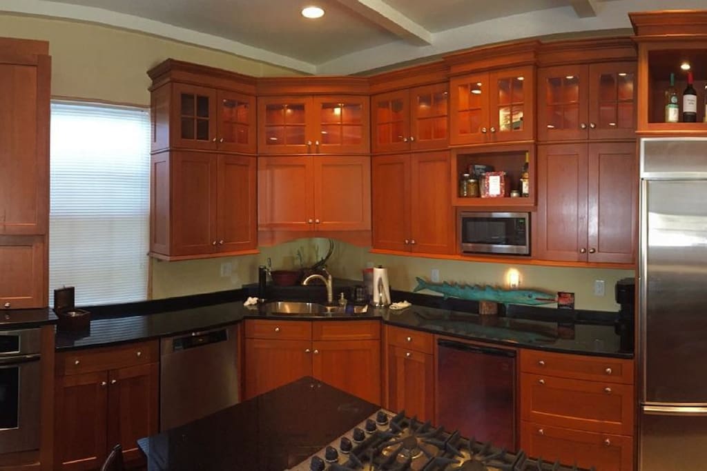 High end custom kitchen with 6 burner Viking cook top and kegerator