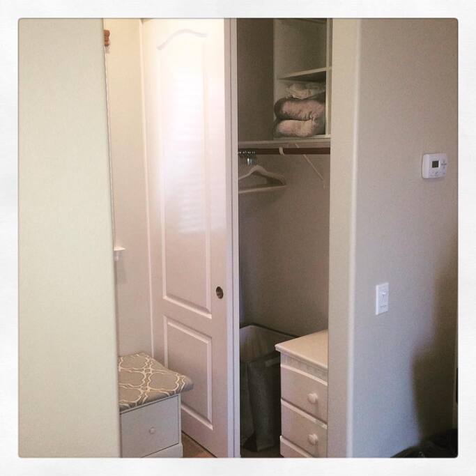 Closet with hangers and two places to put luggage and drawers if you'd prefer to unpack. There is also an iron and ironing board in the room.