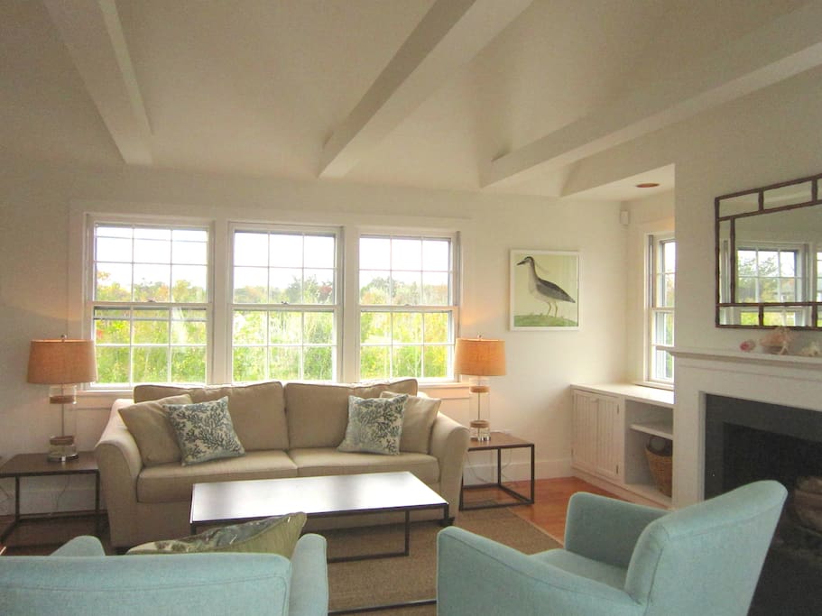 Family room with cathedral ceiling, lovely views and working fireplace
