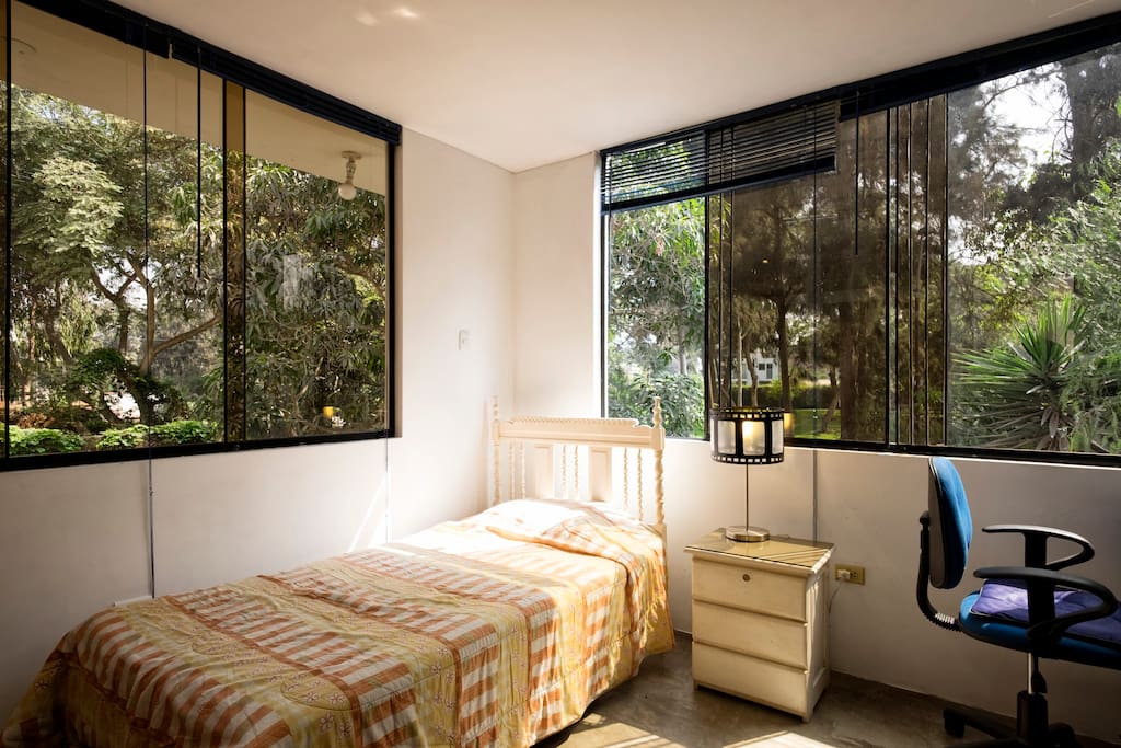 Lots of natural light. Bedroom with working desk, closet, big chest and full bathroom