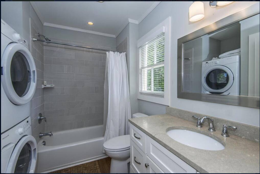 Tile bathroom with washer and dryer
