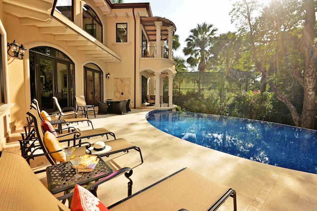 Luxury Home drenched in sunshine. Marble inlaid pool deck by brushed & hammer and pool shower; features non-skid for safety on wet floors and cool foot comfort on hot, sunny days. All patios and pool deck have rubber laid sheeting under marble floors for water proofing as never before seen in Costa Rica. This is used in Luxury home in U.S.