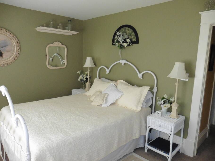 Queen size bed with bay window view.