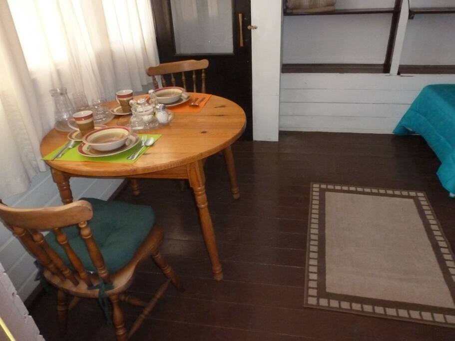Table with two chairs and its complete dish service