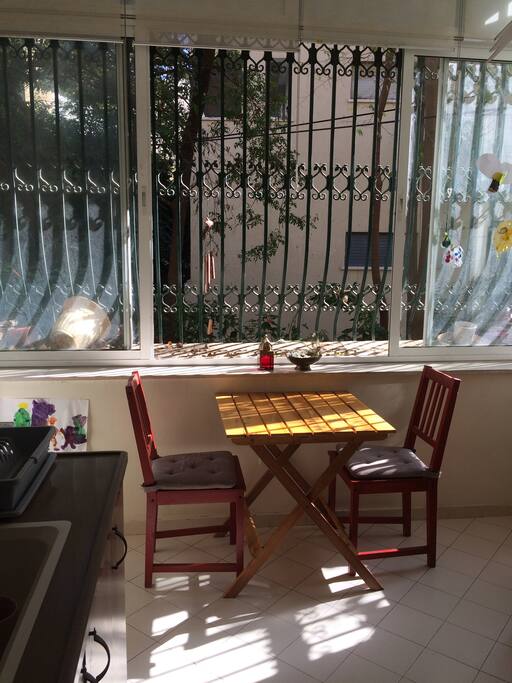 Green view into the back garden, lots of sun and birds singing in the morning. More chairs available.
