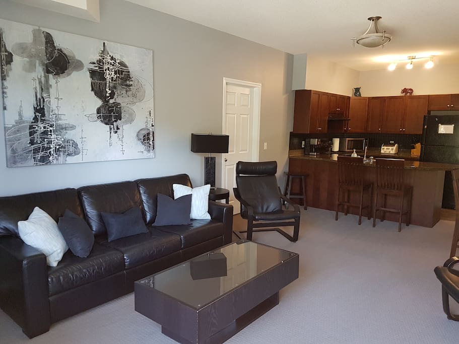 Open concept living room and kitchen with each bedroom located on either side of unit