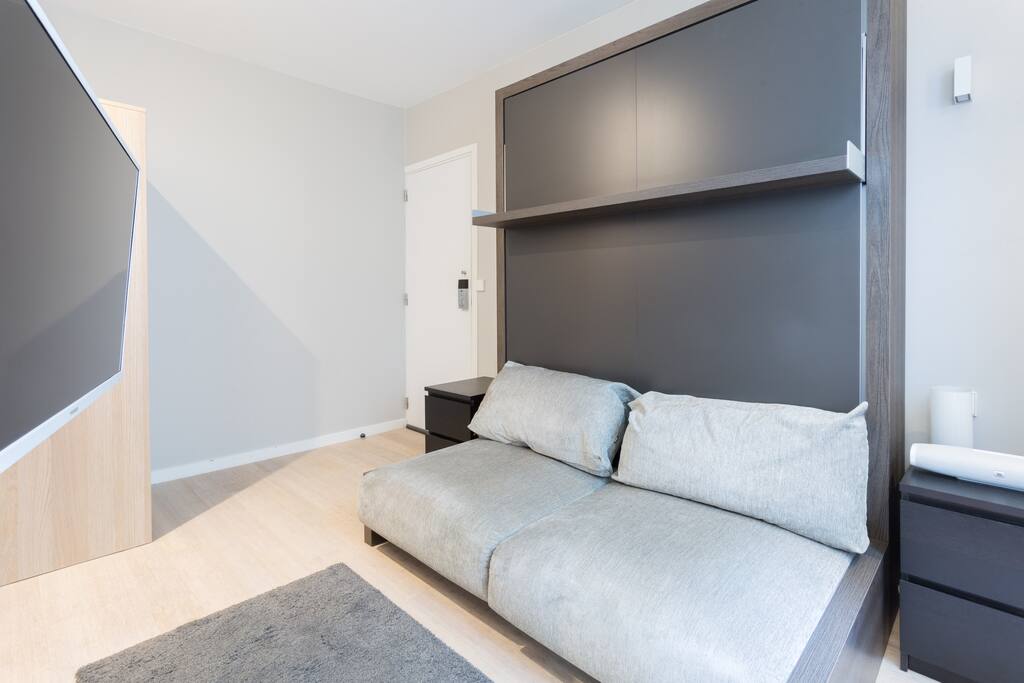 the bed is just behind the sofa