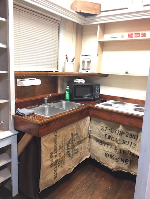 Private kitchenette with microwave, cooktop, coffee pot & mini fridge.