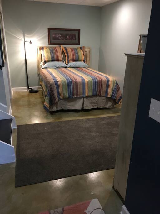 Queen bed in basement.