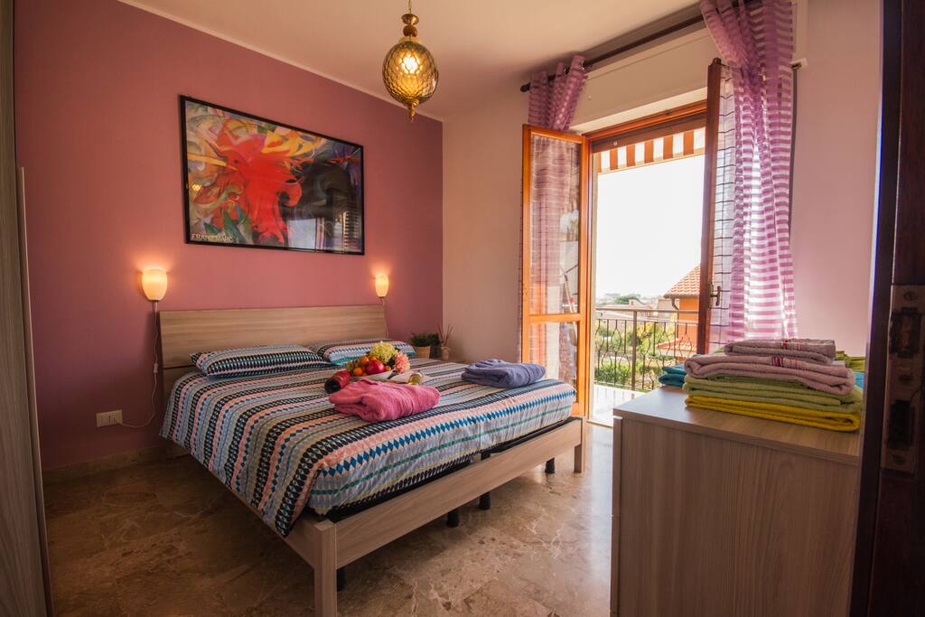 bedroom with small balcony outside overlooking the sea
