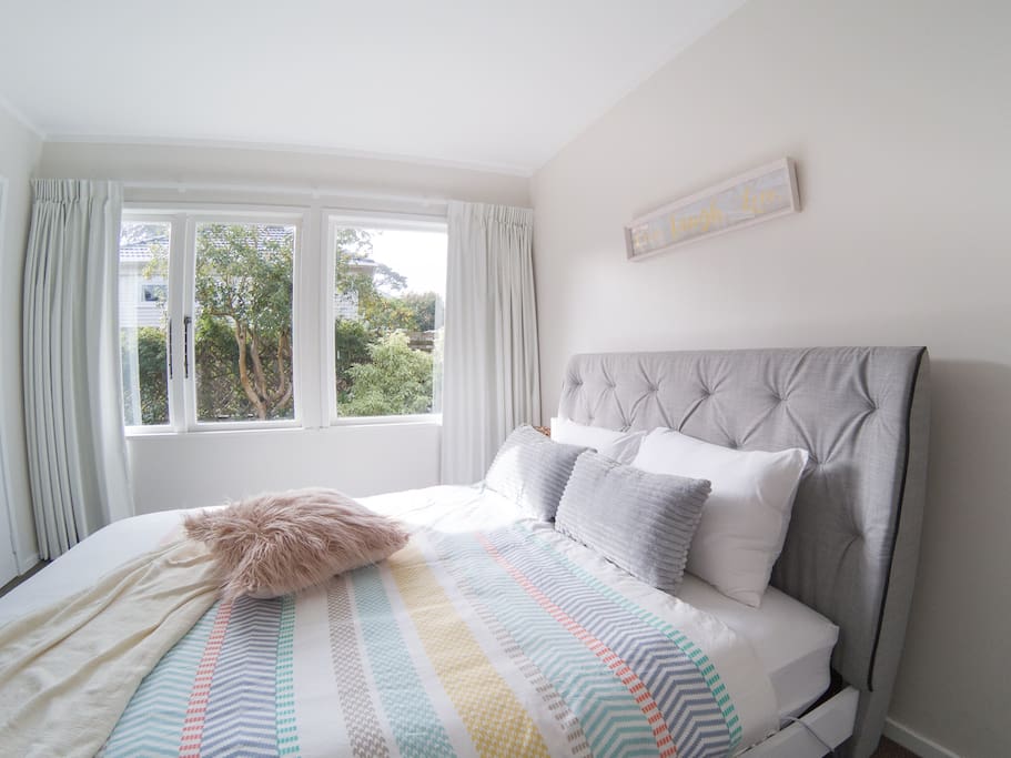 Your bedroom with comfy queen bed and garden view